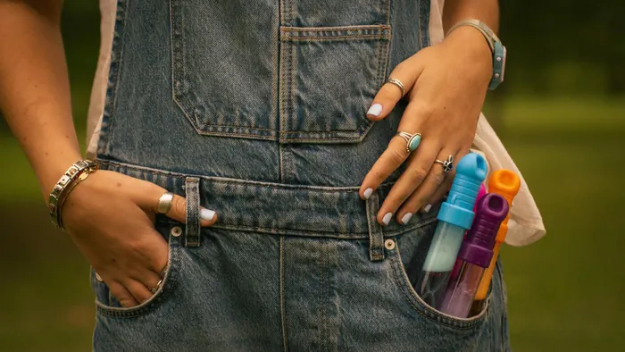 Close-up of hands and pockets on denim overalls